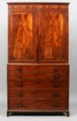 An early 19th century mahogany secretaire linen press
The moulded rectangular cornice above twin