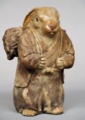 A pottery figure of a rabbit
Modelled in a gown carrying a backpack.  24 cms high.   CONDITION