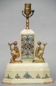 An Art Deco cloisonne mounted alabaster table lamp
The twin blue ground cloisonne panels flanked