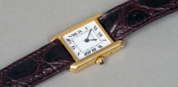 An 18 ct gold Cartier lady's wristwatch
The rectangular dial with Roman numerals and inscribed