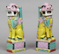 A pair of Chinese porcelain joss stick stands
Each modelled as a dog-of-fo seated on a plinth base.