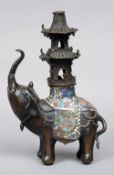 A Chinese cloisonne decorated bronze elephant censor
Modelled trumpeting, a pagoda howdah on his