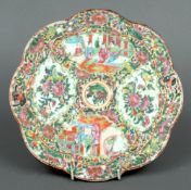 A 19th century Cantonese famille rose porcelain plaque
Of lobe circular form, typically decorated