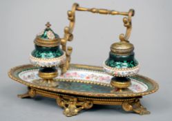 A 19th century gilt metal mounted Bilston enamel desk stand
The oval tray fitted with two ink stands