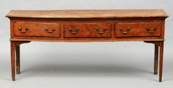 An 18th century elm low dresser
The single plank top above three frieze drawers, standing on