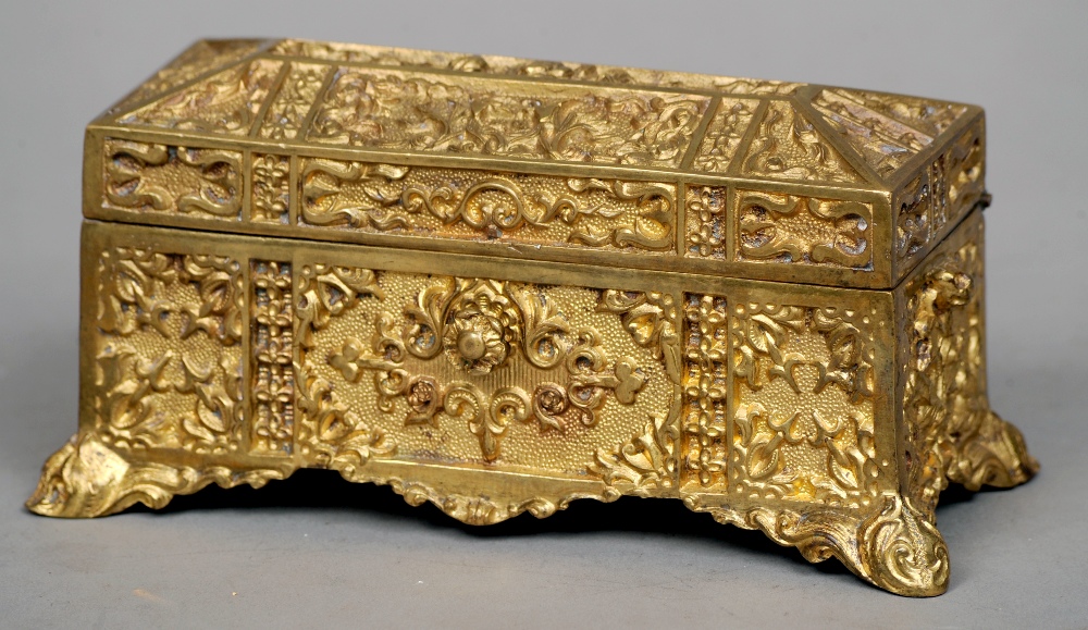 A French gilt bronze casket
The hinged rectangular vessel with allover Gothic Revival decoration.