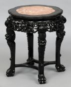 A late 19th century Chinese carved hardwood side table
The bead carved top with a shaped marble