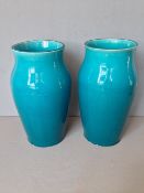 A pair of 19th century Chinese turquoise ground vases
Of plain waisted tapering form.  Each 25 cms