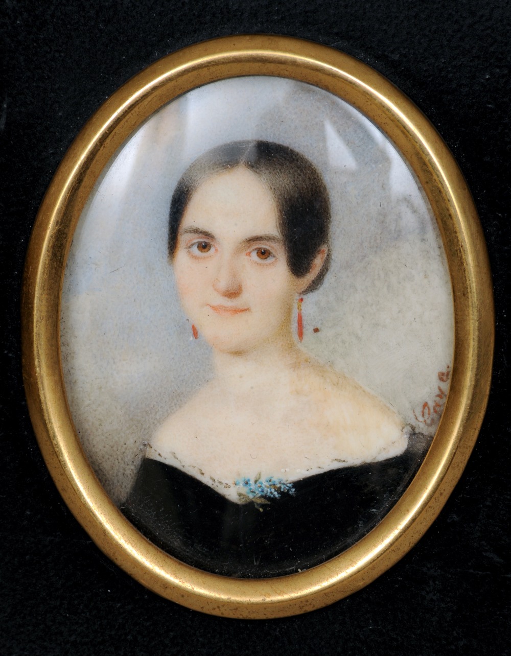 A 19th century portrait miniature on ivory
Depicting a young girl with coral earrings,