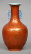 A Chinese porcelain vase
Of baluster form, gilt decorated with lotus strapwork interspersed with