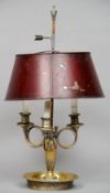 A gilt brass candle lamp
With triple scroll branches and painted adjustable tole ware shade.  56.5