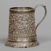 A Victorian unmarked Indian silver Christening mug
Of spreading cylindrical form with a loop handle,