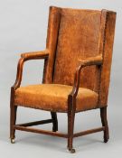 A 19th century leather upholstered oak Gainsborough type chair
Covered in tan leather with open