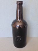 A late 18th/early 19th century green glass wine bottle
Of typical form with applied roundel for