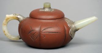 A Chinese jade mounted Yixing teapot
Of squat section form with incised calligraphic decoration, the