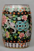 A Chinese porcelain garden seat
Of typical form and decorated in the famille noir palette with