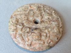 A Chinese carved bi disc
Decorated with a figure with attendants and a frog.  7 cms diameter.