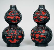 A pair of Chinese double gourd cinnabar lacquered vases
Each decorated with figures and pagodas