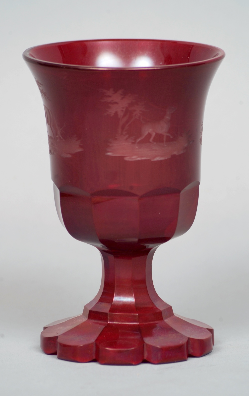 A Bohemian ruby glass goblet
Of typical form and decorated with etched hunting vignettes.  14.5