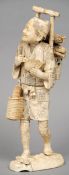 A large 19th century Japanese ivory okimono
Formed as a woodsman, modelled carrying bundles of