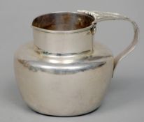 An Edwardian Arts & Crafts style silver jug, hallmarked London 1902, maker's mark of C & M
Of