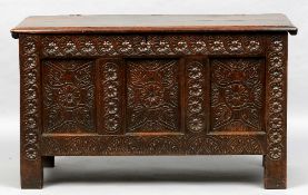 An 18th century carved oak panelled coffer
The moulded rectangular top above the florally carved