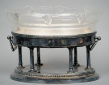 A WMF style glass mounted silver plated centrepiece
The shaped cut glass bowl above the laurel