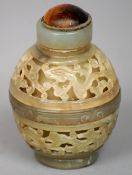 A Chinese pierced and carved jade snuff bottle
The reticulated bands carved with stylised dragons,