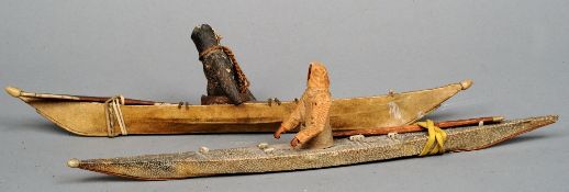 Two 19th century Inuit model kayaks 
One covered in animal hide, the other shagreen.  The former