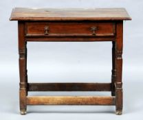 An 18th century oak side table
The rectangular top above a single frieze drawer with brass drop