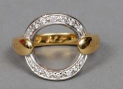 An 18 ct gold designer ring
Set with a circular of diamonds, the shoulders inscribed Asanti.