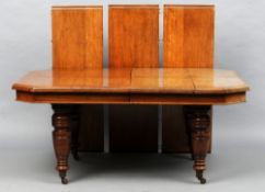 A late Victorian oak wind-out dining table 
The moulded rectangular top with canted corners