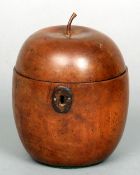 A fruitwood apple form tea caddy
The hinged domed lid enclosing the central recess, above the main