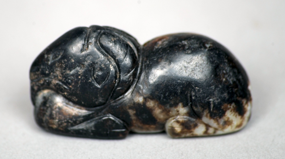 A Chinese pale and russet jade carving
Modelled as a recumbent goat, possibly Song/Ming dynasty.