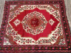 An Azerbaijan wool rug
The wine red field enclosing a central medallion with pendant palmettes and