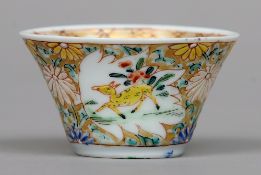 A Chinese porcelain wine cup, possibly 18th century
The exterior decorated with deer vignettes on