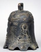 A Tibetan patinated bronze temple bell
Of typical form, decorated with three different scenes of