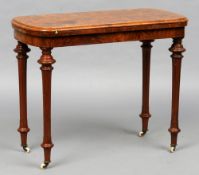 A Victorian burr walnut card table
The inlaid swivelling fold over top with a baize lined playing