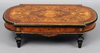 A 19th century marquetry inlaid coffee table
The shaped top inlaid with lions mask floral swags