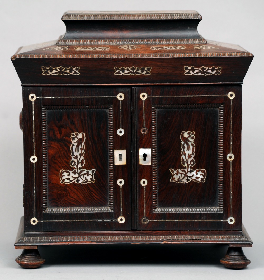 A Regency mother-of-pearl inlaid rosewood table top work box
The interior with various fitted