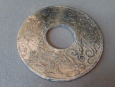 A Chinese carved jade bi disc
Decorated with mythical beasts.  9 cms diameter.   CONDITION REPORTS: