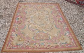 An Aubusson needlepoint rug
The ivory field enclosing a central medallion with pendant palmettes