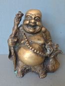 A Chinese polished bronze figure of Hotei
Typically moulded standing holding a staff and his sack of