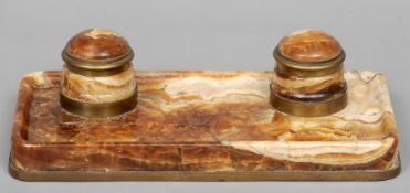 An early 20th century brass mounted alabaster desk stand
With twin lidded inkwells and a pen recess.