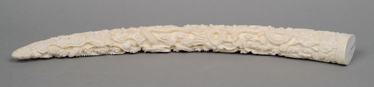 A Chinese ivory group
The tusk profusely carved in the round with dragons within stylised clouds.