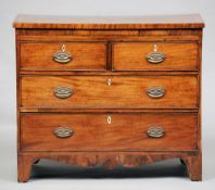 An early 19th century mahogany chest of drawers, of small proportions
The crossbanded top above an