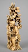 A small 19th century Japanese ivory okimono
Formed as a seated elderly gentleman before a tree,