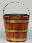 A 19th century brass bound bucket
Of coopered construction with swing handle and liner.  32 cms