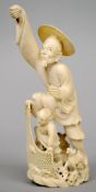 A Japanese carved ivory okimono
Formed as a fisherman and boy hauling in the nets.  20 cms high.