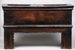 A 17th century German oak coffer
The twin panel top above the plank sides, standing on elongated end